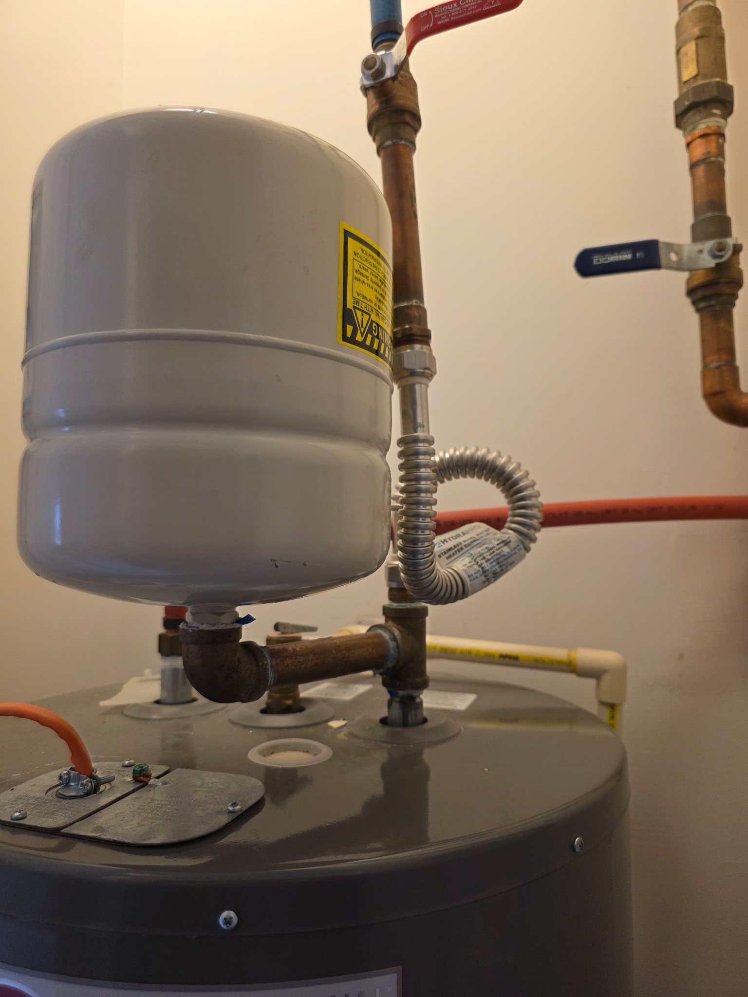 Expansion tank mounted above the water heater in the mechanical closet